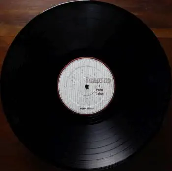 <u>PRESSING INFO</u><br><table class=inf_press><tbody><tr class=inf_info><td class=inf_title>Album:</td><td class=inf_info> From Here To Infirmary on 180g Black (Vagrant 20th Anniversary)  </td></tr>
    <td class=inf_title>Pressing:</td><td> Third Pressing /??  </td></tr>
    <td class=inf_title>Release Date:</td><td> Feb. 8th 2017  </td></tr>
    <td class=inf_title>Album Pressed:</td><td> 2017  </td></tr>
    <td class=inf_title>Label:</td><td> Vagrant Records/BMG VR4405  </td></tr>
    <td class=inf_title>Insert:</td><td> Double Sided Glossy  </td></tr>
    <td class=inf_title>Barcode:</td><td> 4 050538-230147  </td></tr>
    <td class=inf_title>Side A Matrix:</td><td> VR4405-A ALKALINE TRIO-FROM HERE TO INFIRMARY plush v  </td></tr>
    <td class=inf_title>Side B Matrix:</td><td> SP VR4405-B ALKALINE TRIO-HERE TO INFIRMARY plush vinyl  </td></tr>
    <td class=inf_title>&nbsp;</td><td> <a href=https://www.discogs.com/release/9724993 target=_blank rel=noopener noreferrer>View This Release on Discogs</a>  </tr></tbody></table>
<br><u>PRICING</u><span class='less' style='padding-left: 8px; color: var(--font-colour_grey);'>(prices shown in USD)</span><br><table class='inf_press'><tbody><tr class='inf_info'>
            <td class='inf_title'>Last Sold:</td>
            <td>$65.00 (Apr 23, 2026)</td>
            </tr><tr class='inf_info'>
            <td class='inf_title'>History:</td>
            <td>
                <span class='price-low' title='Sold on Jan 8, 2023'>Low: <span class='price-value'>$30.00</span></span>
                <span class='price-separator'>|</span>
                <span class='price-avg'>Avg: <span class='price-value'>$50.77</span></span>
                <span class='price-separator'>|</span>
                <span class='price-high' title='Sold on Apr 20, 2021'>High: <span class='price-value'>$100.00</span></span>
            </td>
            </tr></tbody></table><br>    <br><br><u>TRACKLIST</u><br><table class='inf_tracks'><tbody><tr>
            <td class='inf_num'>A1</td>
            <td class='inf_trk'>Private Eye</td>
            <td class='inf_len'>3:30</td>
            <td><a href='#' class='lyric-link' data-album-code='fhti' data-song-title='Private Eye'>Lyrics</a></td></tr><tr>
            <td class='inf_num'>A2</td>
            <td class='inf_trk'>Mr. Chainsaw</td>
            <td class='inf_len'>3:05</td>
            <td><a href='#' class='lyric-link' data-album-code='fhti' data-song-title='Mr. Chainsaw'>Lyrics</a></td></tr><tr>
            <td class='inf_num'>A3</td>
            <td class='inf_trk'>Take Lots With Alcohol</td>
            <td class='inf_len'>3:13</td>
            <td><a href='#' class='lyric-link' data-album-code='fhti' data-song-title='Take Lots With Alcohol'>Lyrics</a></td></tr><tr>
            <td class='inf_num'>A4</td>
            <td class='inf_trk'>Stupid Kid</td>
            <td class='inf_len'>2:23</td>
            <td><a href='#' class='lyric-link' data-album-code='fhti' data-song-title='Stupid Kid'>Lyrics</a></td></tr><tr>
            <td class='inf_num'>A5</td>
            <td class='inf_trk'>Another Innocent Girl</td>
            <td class='inf_len'>3:37</td>
            <td><a href='#' class='lyric-link' data-album-code='fhti' data-song-title='Another Innocent Girl'>Lyrics</a></td></tr><tr>
            <td class='inf_num'>A6</td>
            <td class='inf_trk'>Steamer Trunk</td>
            <td class='inf_len'>2:50</td>
            <td><a href='#' class='lyric-link' data-album-code='fhti' data-song-title='Steamer Trunk'>Lyrics</a></td></tr><tr>
            <td class='inf_num'>B1</td>
            <td class='inf_trk'>You’re Dead</td>
            <td class='inf_len'>3:50</td>
            <td><a href='#' class='lyric-link' data-album-code='fhti' data-song-title='You’re Dead'>Lyrics</a></td></tr><tr>
            <td class='inf_num'>B2</td>
            <td class='inf_trk'>Armageddon</td>
            <td class='inf_len'>2:49</td>
            <td><a href='#' class='lyric-link' data-album-code='fhti' data-song-title='Armageddon'>Lyrics</a></td></tr><tr>
            <td class='inf_num'>B3</td>
            <td class='inf_trk'>I’m Dying Tomorrow</td>
            <td class='inf_len'>2:18</td>
            <td><a href='#' class='lyric-link' data-album-code='fhti' data-song-title='I’m Dying Tomorrow'>Lyrics</a></td></tr><tr>
            <td class='inf_num'>B4</td>
            <td class='inf_trk'>Bloodied Up</td>
            <td class='inf_len'>2:51</td>
            <td><a href='#' class='lyric-link' data-album-code='fhti' data-song-title='Bloodied Up'>Lyrics</a></td></tr><tr>
            <td class='inf_num'>B5</td>
            <td class='inf_trk'>Trucks And Trains</td>
            <td class='inf_len'>3:16</td>
            <td><a href='#' class='lyric-link' data-album-code='fhti' data-song-title='Trucks And Trains'>Lyrics</a></td></tr><tr>
            <td class='inf_num'>B6</td>
            <td class='inf_trk'>Crawl</td>
            <td class='inf_len'>4:25</td>
            <td><a href='#' class='lyric-link' data-album-code='fhti' data-song-title='Crawl'>Lyrics</a></td></tr></tbody></table><br><br>
    <u>NOTES</u><br> Vagrant Records 20th Anniversary. This pressing was released for Vagrant Records 20th Anniversary. This pressing marks the first time that the album title and tracklisting on the sleeve is in white text instead of red.
 - B