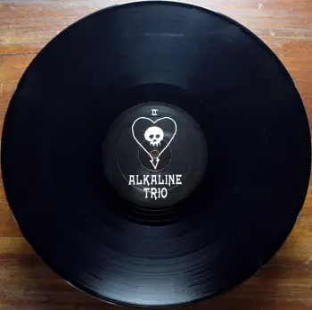 <u>PRESSING INFO</u><br><table class=inf_press><tbody><tr class=inf_info><td class=inf_title>Album:</td><td class=inf_info> Goddamnit on Black (Heart & Skull Labels)  </td></tr>
    <td class=inf_title>Pressing:</td><td> First Pressing /1000  </td></tr>
    <td class=inf_title>Release Date:</td><td> Oct. 13th 1998  </td></tr>
    <td class=inf_title>Album Pressed:</td><td> 1998  </td></tr>
    <td class=inf_title>Label:</td><td> Asianman Records AM-034  </td></tr>
    <td class=inf_title>Insert:</td><td> none  </td></tr>
    <td class=inf_title>Barcode:</td><td> 6 12851-0034-1 5  </td></tr>
    <td class=inf_title>Side A Matrix:</td><td> [etched] AM-034-A L-50793 [stamped] GOLDEN  </td></tr>
    <td class=inf_title>Side B Matrix:</td><td> [etched] AM-034-B L-50793x [stamped] GOLDEN  </td></tr>
    <td class=inf_title>&nbsp;</td><td> <a href=https://www.discogs.com/release/5545758-Alkaline-Trio-Goddamnit target=_blank rel=noopener noreferrer>View This Release on Discogs</a>  </tr></tbody></table>
<br><u>PRICING</u><span class='less' style='padding-left: 8px; color: var(--font-colour_grey);'>(prices shown in USD)</span><br><table class='inf_press'><tbody><tr class='inf_info'>
            <td class='inf_title'>Last Sold:</td>
            <td>$60.00 (Jan 7, 2026)</td>
            </tr><tr class='inf_info'>
            <td class='inf_title'>History:</td>
            <td>
                <span class='price-low' title='Sold on Jul 6, 2017'>Low: <span class='price-value'>$25.00</span></span>
                <span class='price-separator'>|</span>
                <span class='price-avg'>Avg: <span class='price-value'>$104.78</span></span>
                <span class='price-separator'>|</span>
                <span class='price-high' title='Sold on Aug 30, 2022'>High: <span class='price-value'>$200.00</span></span>
            </td>
            </tr></tbody></table><br>    <br><br><u>TRACKLIST</u><br><table class='inf_tracks'><tbody><tr>
            <td class='inf_num'>A1</td>
            <td class='inf_trk'>Cringe</td>
            <td class='inf_len'>2:23</td>
            <td><a href='#' class='lyric-link' data-album-code='gd' data-song-title='Cringe'>Lyrics</a></td></tr><tr>
            <td class='inf_num'>A2</td>
            <td class='inf_trk'>Cop</td>
            <td class='inf_len'>2:18</td>
            <td><a href='#' class='lyric-link' data-album-code='gd' data-song-title='Cop'>Lyrics</a></td></tr><tr>
            <td class='inf_num'>A3</td>
            <td class='inf_trk'>San Francisco</td>
            <td class='inf_len'>3:52</td>
            <td><a href='#' class='lyric-link' data-album-code='gd' data-song-title='San Francisco'>Lyrics</a></td></tr><tr>
            <td class='inf_num'>A4</td>
            <td class='inf_trk'>Nose Over Tail</td>
            <td class='inf_len'>2:37</td>
            <td><a href='#' class='lyric-link' data-album-code='gd' data-song-title='Nose Over Tail'>Lyrics</a></td></tr><tr>
            <td class='inf_num'>A5</td>
            <td class='inf_trk'>As You Were</td>
            <td class='inf_len'>2:11</td>
            <td><a href='#' class='lyric-link' data-album-code='gd' data-song-title='As You Were'>Lyrics</a></td></tr><tr>
            <td class='inf_num'>A6</td>
            <td class='inf_trk'>Enjoy Your Day</td>
            <td class='inf_len'>2:17</td>
            <td><a href='#' class='lyric-link' data-album-code='gd' data-song-title='Enjoy Your Day'>Lyrics</a></td></tr><tr>
            <td class='inf_num'>A7</td>
            <td class='inf_trk'>Clavicle</td>
            <td class='inf_len'>2:28</td>
            <td><a href='#' class='lyric-link' data-album-code='gd' data-song-title='Clavicle'>Lyrics</a></td></tr><tr>
            <td class='inf_num'>B1</td>
            <td class='inf_trk'>My Little Needle</td>
            <td class='inf_len'>3:01</td>
            <td><a href='#' class='lyric-link' data-album-code='gd' data-song-title='My Little Needle'>Lyrics</a></td></tr><tr>
            <td class='inf_num'>B2</td>
            <td class='inf_trk'>Southern Rock</td>
            <td class='inf_len'>3:05</td>
            <td><a href='#' class='lyric-link' data-album-code='gd' data-song-title='Southern Rock'>Lyrics</a></td></tr><tr>
            <td class='inf_num'>B3</td>
            <td class='inf_trk'>Message From Kathlene</td>
            <td class='inf_len'>3:22</td>
            <td><a href='#' class='lyric-link' data-album-code='gd' data-song-title='Message From Kathlene'>Lyrics</a></td></tr><tr>
            <td class='inf_num'>B4</td>
            <td class='inf_trk'>Trouble Breathing</td>
            <td class='inf_len'>3:55</td>
            <td><a href='#' class='lyric-link' data-album-code='gd' data-song-title='Trouble Breathing'>Lyrics</a></td></tr><tr>
            <td class='inf_num'>B5</td>
            <td class='inf_trk'>Sorry About That</td>
            <td class='inf_len'>3:21</td>
            <td><a href='#' class='lyric-link' data-album-code='gd' data-song-title='Sorry About That'>Lyrics</a></td></tr></tbody></table><br><br>
    <u>NOTES</u><br> The original version of this LP was pressed with a total quantity of 2000. There were 1,000 black clock labels and 1,000 black heart/skull labels (this). This 1st pressing is the only pressing to feature the original black cover art. The Heart & Skull Label variant did not come with an insert.
 - B