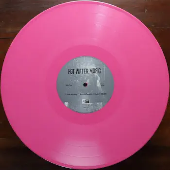 <u>PRESSING INFO</u><br><table class=inf_press><tbody><tr class=inf_info><td class=inf_title>Album:</td><td class=inf_info> Hot Water Music Split on Hot Pink (Urban Outfitters Exclusive)  </td></tr>
    <td class=inf_title>Pressing:</td><td> Eighth Pressing /2000  </td></tr>
    <td class=inf_title>Release Date:</td><td> Jan. 27th 2023  </td></tr>
    <td class=inf_title>Album Pressed:</td><td> 2023  </td></tr>
    <td class=inf_title>Label:</td><td> Jade Tree Records JT1067 82119-1  </td></tr>
    <td class=inf_title>Insert:</td><td> Printed Glossy Inner Sleeve  </td></tr>
    <td class=inf_title>Barcode:</td><td> 0 45778-21191 3  </td></tr>
    <td class=inf_title>Side A Matrix:</td><td> EPTÂ·82119Â·1Â·A SAFF  </td></tr>
    <td class=inf_title>Side B Matrix:</td><td> EPTÂ·82119Â·1Â·B SAFF  </td></tr>
    <td class=inf_title>&nbsp;</td><td> <a href=https://www.discogs.com/release/25981831 target=_blank rel=noopener noreferrer>View This Release on Discogs</a>  </tr></tbody></table>
<br><u>PRICING</u><span class='less' style='padding-left: 8px; color: var(--font-colour_grey);'>(prices shown in USD)</span><br><table class='inf_press'><tbody><tr class='inf_info'>
            <td class='inf_title'>Last Sold:</td>
            <td>$23.76 (May 22, 2026)</td>
            </tr><tr class='inf_info'>
            <td class='inf_title'>History:</td>
            <td>
                <span class='price-low' title='Sold on Sep 5, 2024'>Low: <span class='price-value'>$6.00</span></span>
                <span class='price-separator'>|</span>
                <span class='price-avg'>Avg: <span class='price-value'>$14.50</span></span>
                <span class='price-separator'>|</span>
                <span class='price-high' title='€37.99 · Sold on Feb 26, 2025'>High: <span class='price-value'>$43.27</span></span>
            </td>
            </tr></tbody></table><br>    <br><br><u>TRACKLIST</u><br><table class='inf_tracks'><tbody><tr>
            <td class='inf_num'>A1</td>
            <td class='inf_trk'>Alkaline Trio - Queen Of Pain</td>
            <td class='inf_len'>3:57</td>
            <td><a href='#' class='lyric-link' data-album-code='splits' data-song-title='Alkaline Trio - Queen Of Pain'>Lyrics</a></td></tr><tr>
            <td class='inf_num'>A2</td>
            <td class='inf_trk'>Alkaline Trio - While You’re Waiting</td>
            <td class='inf_len'>4:07</td>
            <td><a href='#' class='lyric-link' data-album-code='splits' data-song-title='Alkaline Trio - While You’re Waiting'>Lyrics</a></td></tr><tr>
            <td class='inf_num'>A3</td>
            <td class='inf_trk'>Alkaline Trio - Rooftops</td>
            <td class='inf_len'>2:15</td>
            <td><a href='#' class='lyric-link' data-album-code='splits' data-song-title='Alkaline Trio - Rooftops'>Lyrics</a></td></tr><tr>
            <td class='inf_num'>B1</td>
            <td class='inf_trk'>Hot Water Music - God Deciding</td>
            <td class='inf_len'>2:37</td>
            <td><a href='#' class='lyric-link' data-album-code='splits' data-song-title='Hot Water Music - God Deciding'>Lyrics</a></td></tr><tr>
            <td class='inf_num'>B2</td>
            <td class='inf_trk'>Hot Water Music - Russian Roulette</td>
            <td class='inf_len'>3:25</td>
            <td><a href='#' class='lyric-link' data-album-code='splits' data-song-title='Hot Water Music - Russian Roulette'>Lyrics</a></td></tr><tr>
            <td class='inf_num'>B3</td>
            <td class='inf_trk'>Hot Water Music - Radio</td>
            <td class='inf_len'>4:12</td>
            <td><a href='#' class='lyric-link' data-album-code='splits' data-song-title='Hot Water Music - Radio'>Lyrics</a></td></tr><tr>
            <td class='inf_num'>B4</td>
            <td class='inf_trk'>Hot Water Music - Bleeder</td>
            <td class='inf_len'>3:13</td>
            <td><a href='#' class='lyric-link' data-album-code='splits' data-song-title='Hot Water Music - Bleeder'>Lyrics</a></td></tr></tbody></table><br><br>
    <u>NOTES</u><br> Printed inner sleeve (Heavier cardstock and slightly glossier finish compared to 1st presses)
 - B