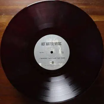 <u>PRESSING INFO</u><br><table class=inf_press><tbody><tr class=inf_info><td class=inf_title>Album:</td><td class=inf_info> Hot Water Music Split on Ruby with Black Marble (Newbury Comics Exclusive)  </td></tr>
    <td class=inf_title>Pressing:</td><td> Seventh Pressing /500  </td></tr>
    <td class=inf_title>Release Date:</td><td> July 29th 2022  </td></tr>
    <td class=inf_title>Album Pressed:</td><td> 2022  </td></tr>
    <td class=inf_title>Label:</td><td> Jade Tree Records JT1067 82119-1  </td></tr>
    <td class=inf_title>Insert:</td><td> Printed Glossy Inner Sleeve  </td></tr>
    <td class=inf_title>Barcode:</td><td> 0 45778-21191 3  </td></tr>
    <td class=inf_title>Side A Matrix:</td><td> EPT·82119·1·A SAFF  </td></tr>
    <td class=inf_title>Side B Matrix:</td><td> EPT·82119·1·B SAFF  </td></tr>
    <td class=inf_title>&nbsp;</td><td> <a href=https://www.discogs.com/release/24047864 target=_blank rel=noopener noreferrer>View This Release on Discogs</a>  </tr></tbody></table>
<br><u>PRICING</u><span class='less' style='padding-left: 8px; color: var(--font-colour_grey);'>(prices shown in USD)</span><br><table class='inf_press'><tbody><tr class='inf_info'>
            <td class='inf_title'>Last Sold:</td>
            <td>$9.52 (Jan 23, 2025)</td>
            </tr><tr class='inf_info'>
            <td class='inf_title'>History:</td>
            <td>
                <span class='price-low' title='Sold on Jan 23, 2025'>Low: <span class='price-value'>$9.52</span></span>
                <span class='price-separator'>|</span>
                <span class='price-avg'>Avg: <span class='price-value'>$32.71</span></span>
                <span class='price-separator'>|</span>
                <span class='price-high' title='Sold on Aug 1, 2022'>High: <span class='price-value'>$59.99</span></span>
            </td>
            </tr></tbody></table><br>    <br><br><u>TRACKLIST</u><br><table class='inf_tracks'><tbody><tr>
            <td class='inf_num'>A1</td>
            <td class='inf_trk'>Alkaline Trio - Queen Of Pain</td>
            <td class='inf_len'>3:57</td>
            <td><a href='#' class='lyric-link' data-album-code='splits' data-song-title='Alkaline Trio - Queen Of Pain'>Lyrics</a></td></tr><tr>
            <td class='inf_num'>A2</td>
            <td class='inf_trk'>Alkaline Trio - While You’re Waiting</td>
            <td class='inf_len'>4:07</td>
            <td><a href='#' class='lyric-link' data-album-code='splits' data-song-title='Alkaline Trio - While You’re Waiting'>Lyrics</a></td></tr><tr>
            <td class='inf_num'>A3</td>
            <td class='inf_trk'>Alkaline Trio - Rooftops</td>
            <td class='inf_len'>2:15</td>
            <td><a href='#' class='lyric-link' data-album-code='splits' data-song-title='Alkaline Trio - Rooftops'>Lyrics</a></td></tr><tr>
            <td class='inf_num'>B1</td>
            <td class='inf_trk'>Hot Water Music - God Deciding</td>
            <td class='inf_len'>2:37</td>
            <td><a href='#' class='lyric-link' data-album-code='splits' data-song-title='Hot Water Music - God Deciding'>Lyrics</a></td></tr><tr>
            <td class='inf_num'>B2</td>
            <td class='inf_trk'>Hot Water Music - Russian Roulette</td>
            <td class='inf_len'>3:25</td>
            <td><a href='#' class='lyric-link' data-album-code='splits' data-song-title='Hot Water Music - Russian Roulette'>Lyrics</a></td></tr><tr>
            <td class='inf_num'>B3</td>
            <td class='inf_trk'>Hot Water Music - Radio</td>
            <td class='inf_len'>4:12</td>
            <td><a href='#' class='lyric-link' data-album-code='splits' data-song-title='Hot Water Music - Radio'>Lyrics</a></td></tr><tr>
            <td class='inf_num'>B4</td>
            <td class='inf_trk'>Hot Water Music - Bleeder</td>
            <td class='inf_len'>3:13</td>
            <td><a href='#' class='lyric-link' data-album-code='splits' data-song-title='Hot Water Music - Bleeder'>Lyrics</a></td></tr></tbody></table><br><br>
    <u>NOTES</u><br> Printed inner sleeve (Heavier cardstock and slightly glossier finish compared to 1st presses)
 - A2
