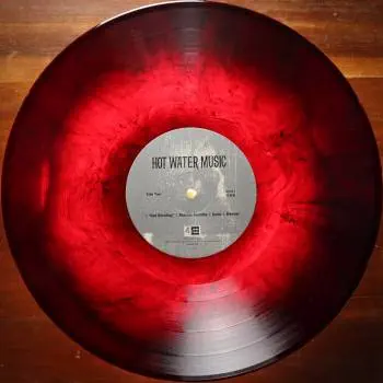 <u>PRESSING INFO</u><br><table class=inf_press><tbody><tr class=inf_info><td class=inf_title>Album:</td><td class=inf_info> Hot Water Music Split on Ruby with Black Marble (Newbury Comics Exclusive)  </td></tr>
    <td class=inf_title>Pressing:</td><td> Seventh Pressing /500  </td></tr>
    <td class=inf_title>Release Date:</td><td> July 29th 2022  </td></tr>
    <td class=inf_title>Album Pressed:</td><td> 2022  </td></tr>
    <td class=inf_title>Label:</td><td> Jade Tree Records JT1067 82119-1  </td></tr>
    <td class=inf_title>Insert:</td><td> Printed Glossy Inner Sleeve  </td></tr>
    <td class=inf_title>Barcode:</td><td> 0 45778-21191 3  </td></tr>
    <td class=inf_title>Side A Matrix:</td><td> EPT·82119·1·A SAFF  </td></tr>
    <td class=inf_title>Side B Matrix:</td><td> EPT·82119·1·B SAFF  </td></tr>
    <td class=inf_title>&nbsp;</td><td> <a href=https://www.discogs.com/release/24047864 target=_blank rel=noopener noreferrer>View This Release on Discogs</a>  </tr></tbody></table>
<br><u>PRICING</u><span class='less' style='padding-left: 8px; color: var(--font-colour_grey);'>(prices shown in USD)</span><br><table class='inf_press'><tbody><tr class='inf_info'>
            <td class='inf_title'>Last Sold:</td>
            <td>$9.52 (Jan 23, 2025)</td>
            </tr><tr class='inf_info'>
            <td class='inf_title'>History:</td>
            <td>
                <span class='price-low' title='Sold on Jan 23, 2025'>Low: <span class='price-value'>$9.52</span></span>
                <span class='price-separator'>|</span>
                <span class='price-avg'>Avg: <span class='price-value'>$32.71</span></span>
                <span class='price-separator'>|</span>
                <span class='price-high' title='Sold on Aug 1, 2022'>High: <span class='price-value'>$59.99</span></span>
            </td>
            </tr></tbody></table><br>    <br><br><u>TRACKLIST</u><br><table class='inf_tracks'><tbody><tr>
            <td class='inf_num'>A1</td>
            <td class='inf_trk'>Alkaline Trio - Queen Of Pain</td>
            <td class='inf_len'>3:57</td>
            <td><a href='#' class='lyric-link' data-album-code='splits' data-song-title='Alkaline Trio - Queen Of Pain'>Lyrics</a></td></tr><tr>
            <td class='inf_num'>A2</td>
            <td class='inf_trk'>Alkaline Trio - While You’re Waiting</td>
            <td class='inf_len'>4:07</td>
            <td><a href='#' class='lyric-link' data-album-code='splits' data-song-title='Alkaline Trio - While You’re Waiting'>Lyrics</a></td></tr><tr>
            <td class='inf_num'>A3</td>
            <td class='inf_trk'>Alkaline Trio - Rooftops</td>
            <td class='inf_len'>2:15</td>
            <td><a href='#' class='lyric-link' data-album-code='splits' data-song-title='Alkaline Trio - Rooftops'>Lyrics</a></td></tr><tr>
            <td class='inf_num'>B1</td>
            <td class='inf_trk'>Hot Water Music - God Deciding</td>
            <td class='inf_len'>2:37</td>
            <td><a href='#' class='lyric-link' data-album-code='splits' data-song-title='Hot Water Music - God Deciding'>Lyrics</a></td></tr><tr>
            <td class='inf_num'>B2</td>
            <td class='inf_trk'>Hot Water Music - Russian Roulette</td>
            <td class='inf_len'>3:25</td>
            <td><a href='#' class='lyric-link' data-album-code='splits' data-song-title='Hot Water Music - Russian Roulette'>Lyrics</a></td></tr><tr>
            <td class='inf_num'>B3</td>
            <td class='inf_trk'>Hot Water Music - Radio</td>
            <td class='inf_len'>4:12</td>
            <td><a href='#' class='lyric-link' data-album-code='splits' data-song-title='Hot Water Music - Radio'>Lyrics</a></td></tr><tr>
            <td class='inf_num'>B4</td>
            <td class='inf_trk'>Hot Water Music - Bleeder</td>
            <td class='inf_len'>3:13</td>
            <td><a href='#' class='lyric-link' data-album-code='splits' data-song-title='Hot Water Music - Bleeder'>Lyrics</a></td></tr></tbody></table><br><br>
    <u>NOTES</u><br> Printed inner sleeve (Heavier cardstock and slightly glossier finish compared to 1st presses)
 - B